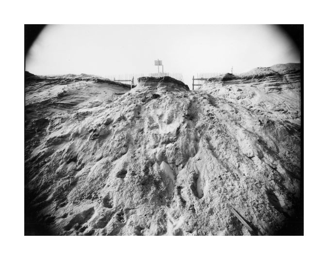 "Newcomb Hollow Spring" by James Abbott. A Gelatin silver print depicting a sand dune eroding away from a fence. landscape, Black and White, Photograph, Nature. The Print Center